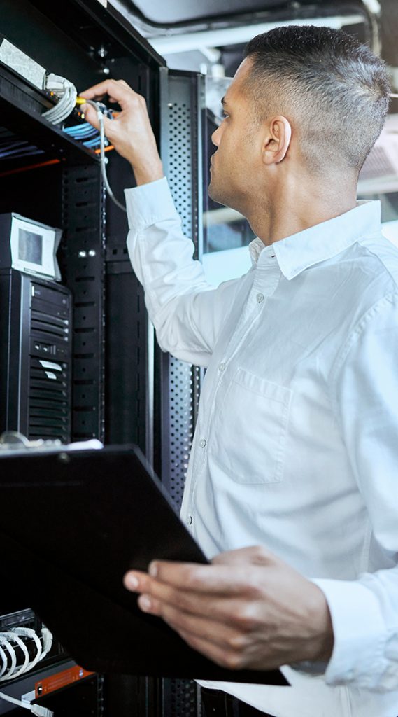man working on a computer server 
